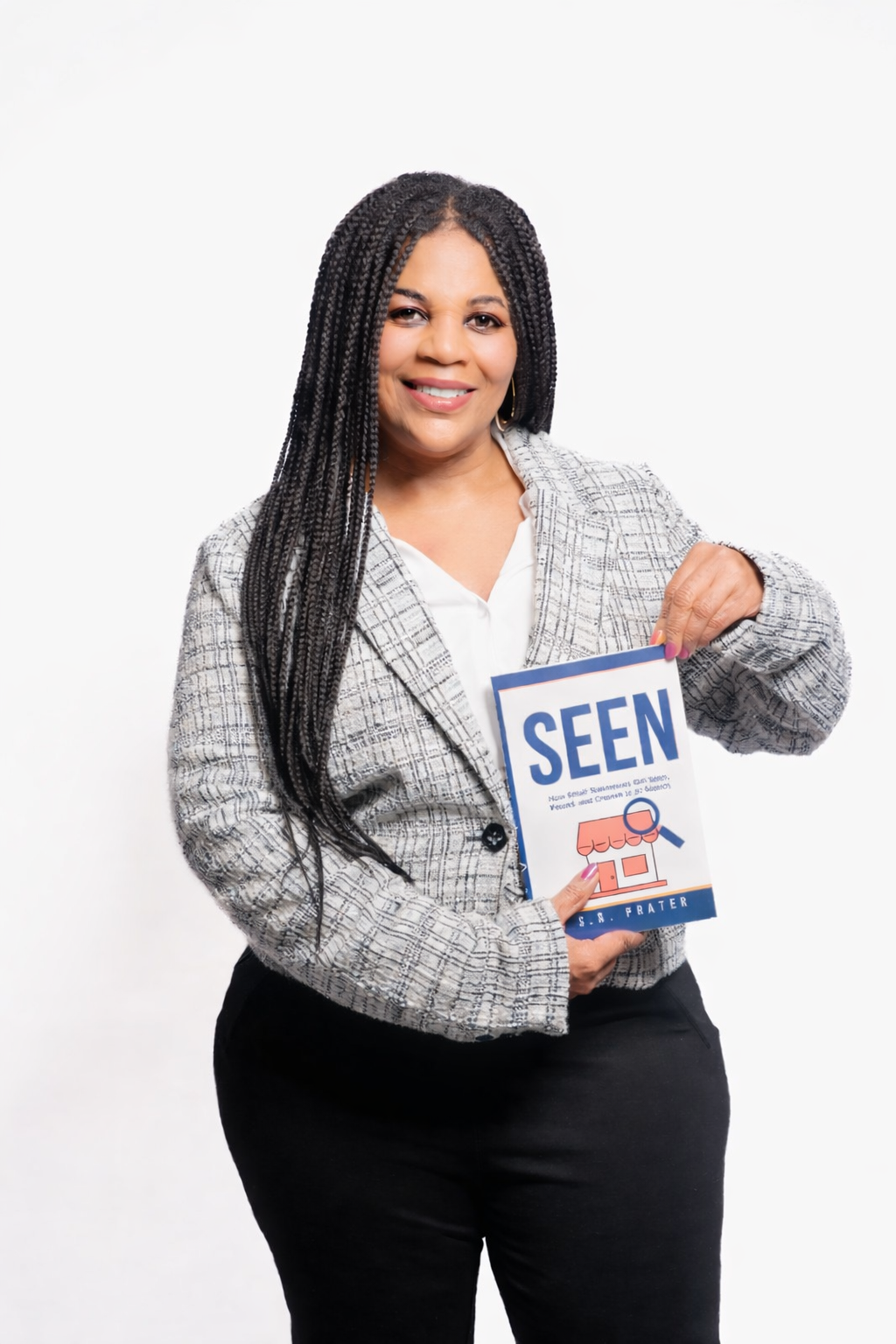 Author S.R. Prater smiling and holding a copy of her book SEEN